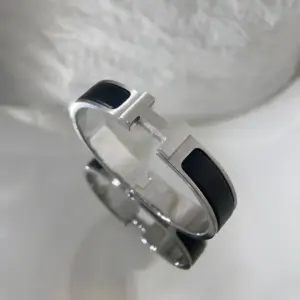 Hermès black master bracelet with silver border