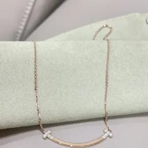 Tiffany drilled smiley face necklace